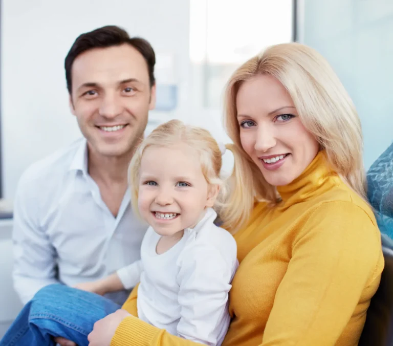 Parents and child smiling together